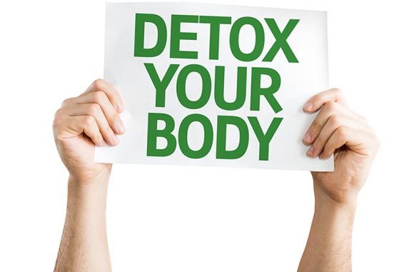 Hands holding sign saying, Detox Your Body.